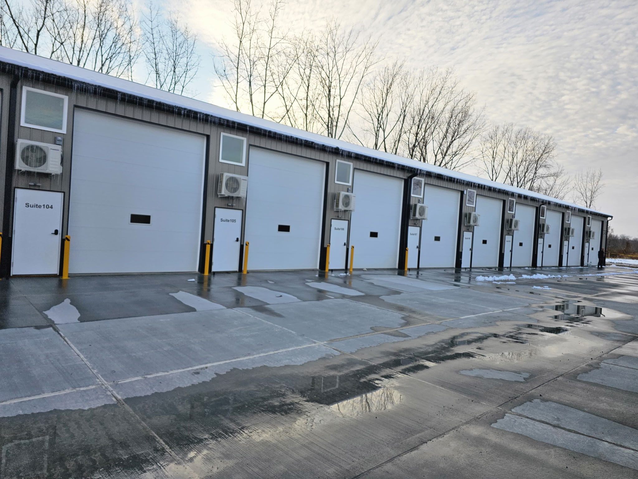 Closer front view of Buckeye Flex Space suites with business signs and vehicles in the lot